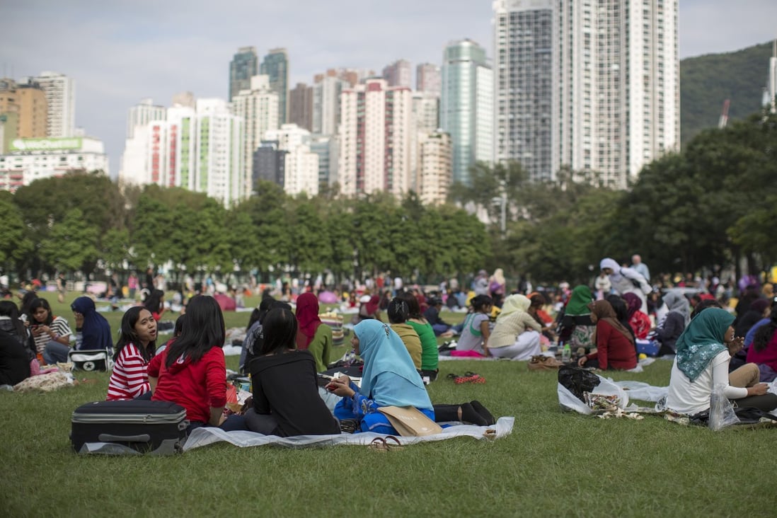 Migrant workers in Hong Kong’s Victoria Park during their day off. Photo: Bloomberg