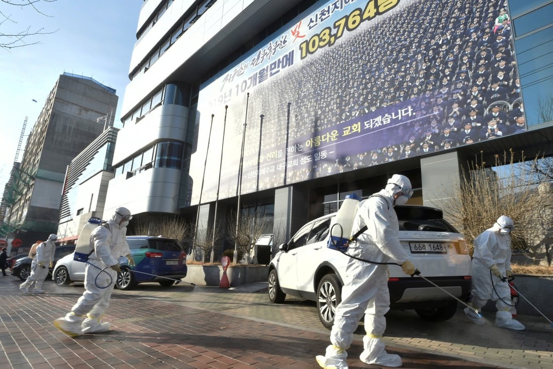 Workers sanitise a street in front of a branch of the Shincheonji Church of Jesus in Daegu. Photo: Reuters