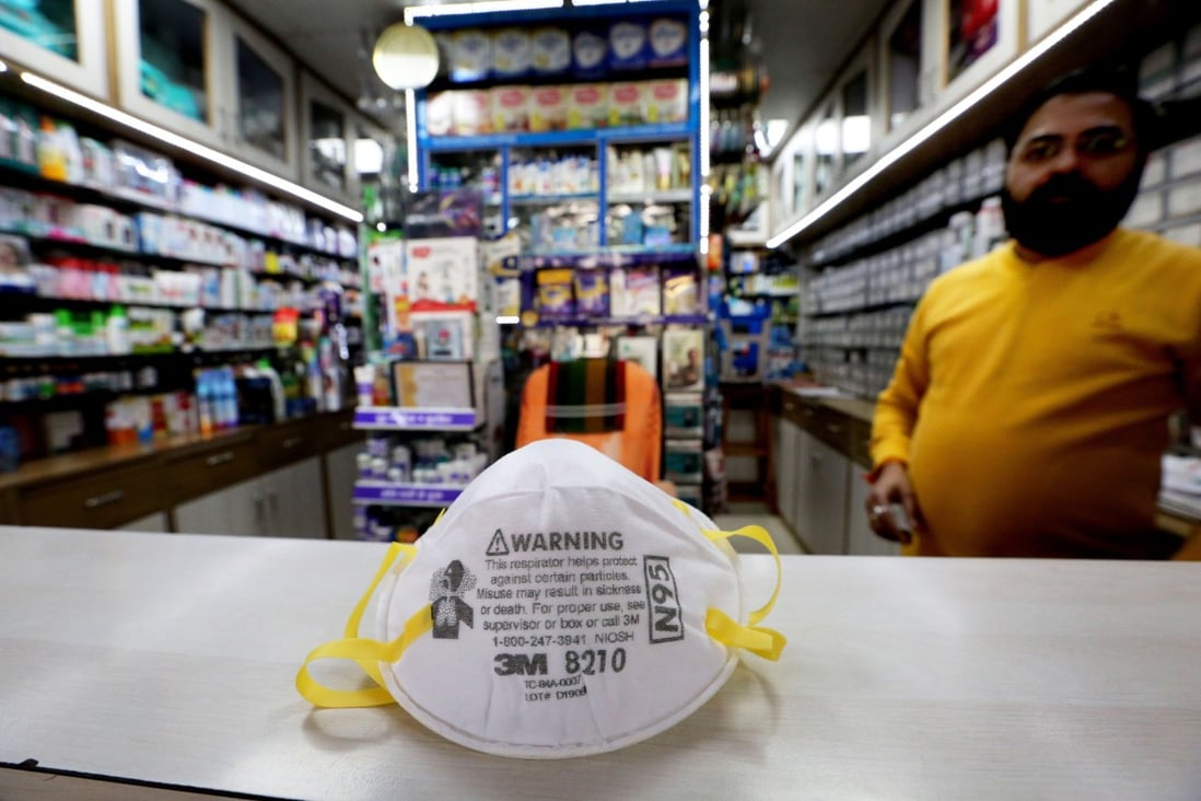 A vendor shows an N95 face mask at medical store in Bhopal, India. Photo: EPA