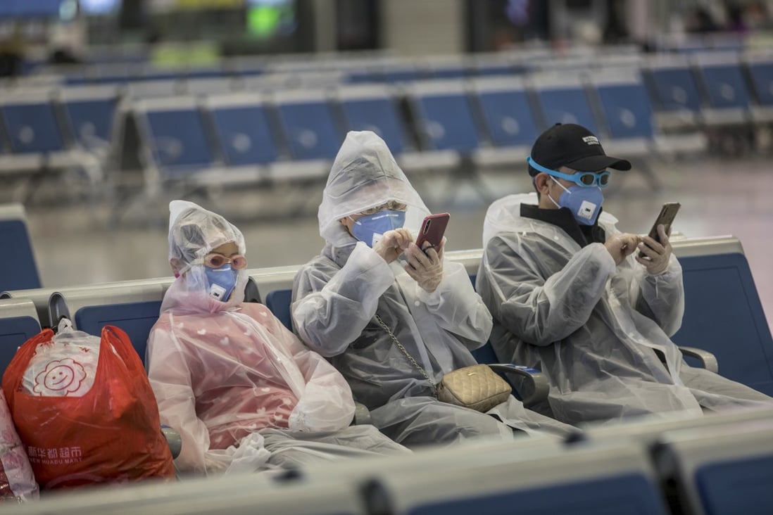 A family wearing masks and makeshift protection gear wait for their train at the Hongqiao high-speed railway station in Shanghai on February 11. More than 75,000 cases of coronavirus infection have so far been reported with over 2,000 deaths. Photo: Bloomberg