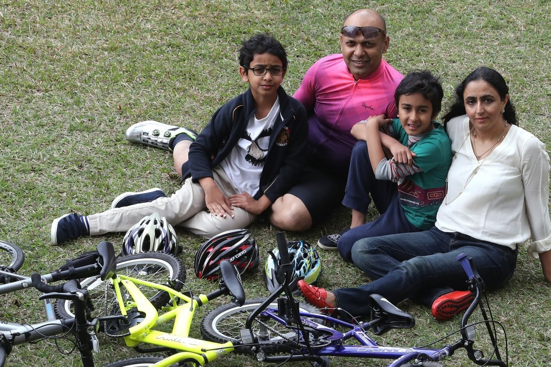 Dexter D’Souza (second from left), a cancer survivor who ran the 2017 New York City Marathon with a then undiscovered tumour growing in his leg, with his wife and two sons. Photo: SCMP / Edward Wong