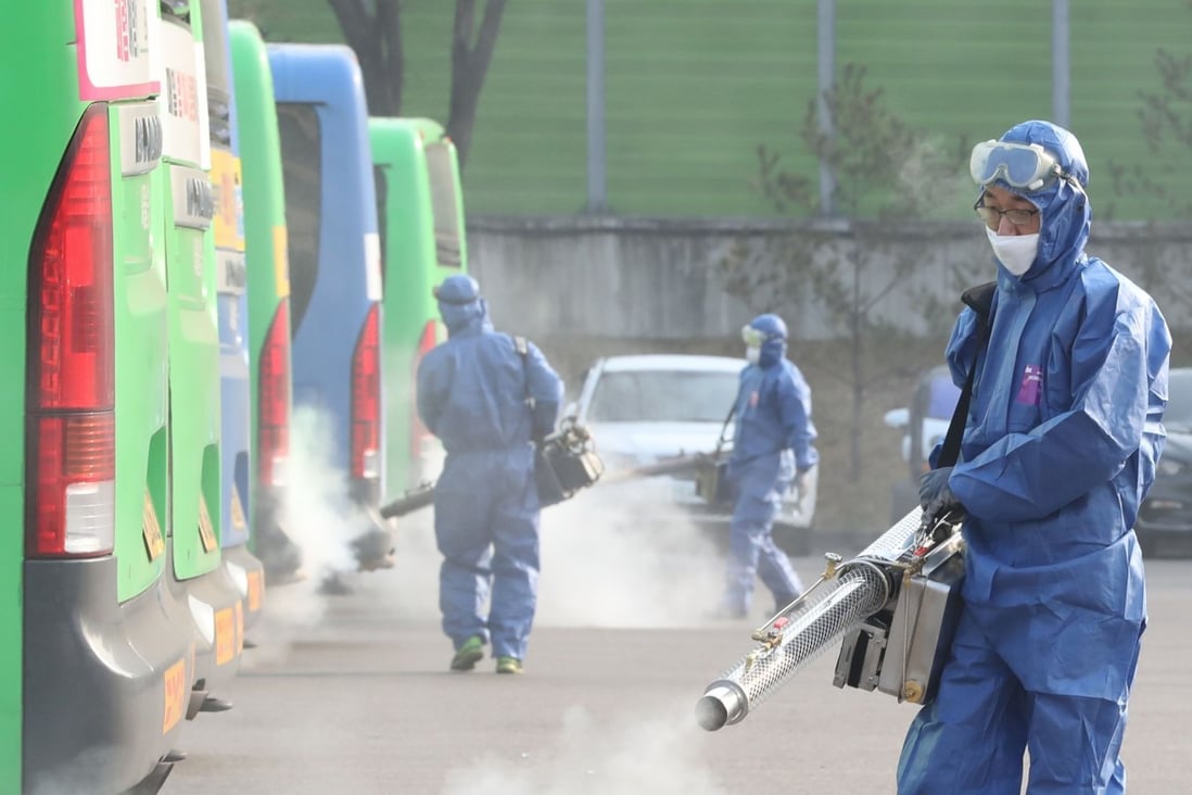 Workers spray disinfectant at a public bus terminal in Seoul. Photo: Agence France-Presse