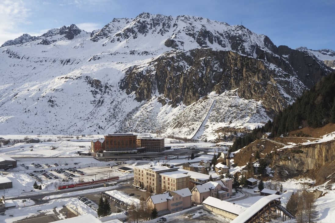 The Andermatt Swiss Alps project will fill much of the area on the far side of the railway track – the cluster of darker buildings below the mountain are the first of many new ones planned for the village. Photo: Mark Footer