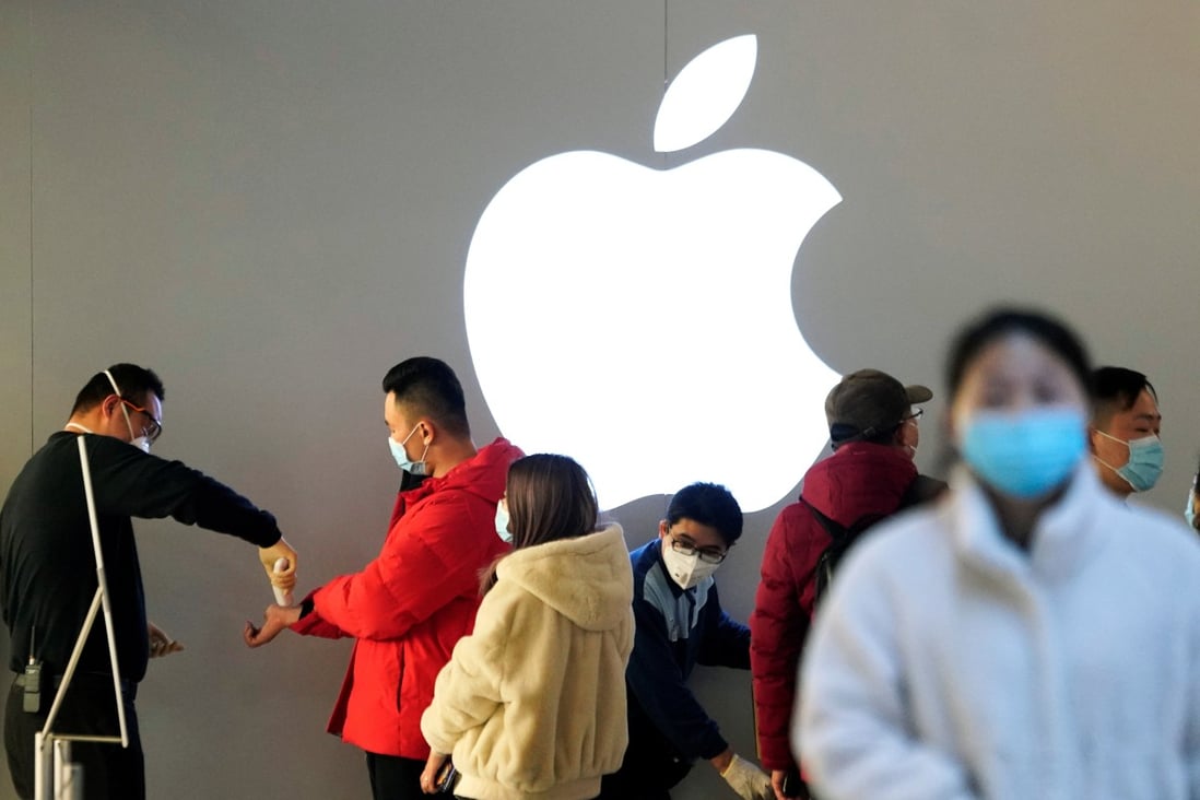 Customers at an Apple Store in Shanghai on Friday wait to have their temperature checked before entering. Photo: Reuters