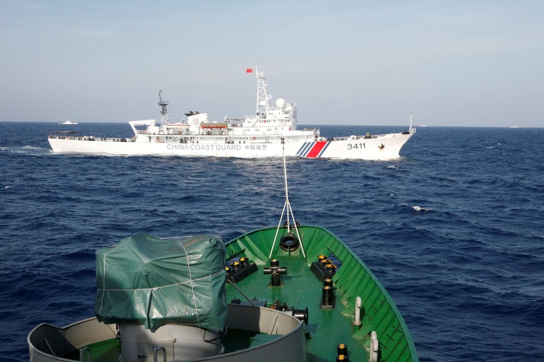 A Chinese Coast Guard is seen near a ship of the Vietnam Marine Guard in the South China Sea. Photo: Reuters