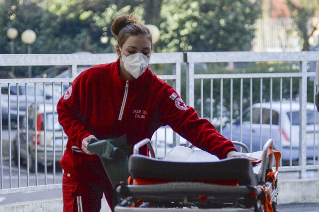 A member of the Italian Red Cross prepares a stretcher outside the Codogno Civic Hospital in Lodi, northern Italy, on Friday. Photo: EPA-EFE