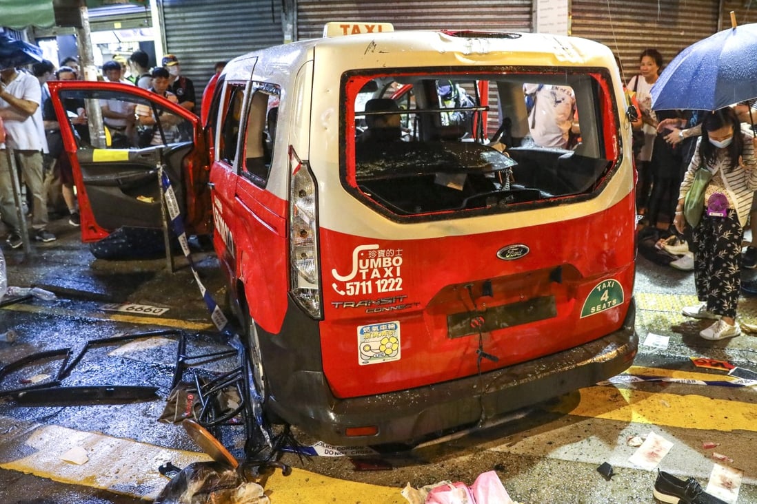 Protesters descended on the taxi after it ploughed into a crowd at a rally, smashing the vehicle and beating up the driver. Photo: K.Y. Cheng