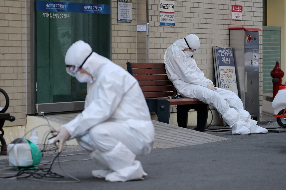 A medical worker takes rest outside a hospital in Daegu, South Korea. Photo: Reuters
