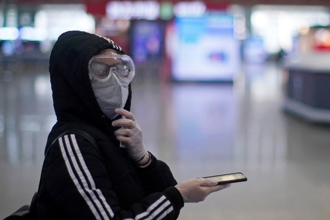 A woman wears a protective face mask inside the Shanghai Hongqiao railway station on the last day of the Spring Festival travel rush, as the country is hit by the novel coronavirus outbreak, in Shanghai, China February 18, 2020. REUTERS