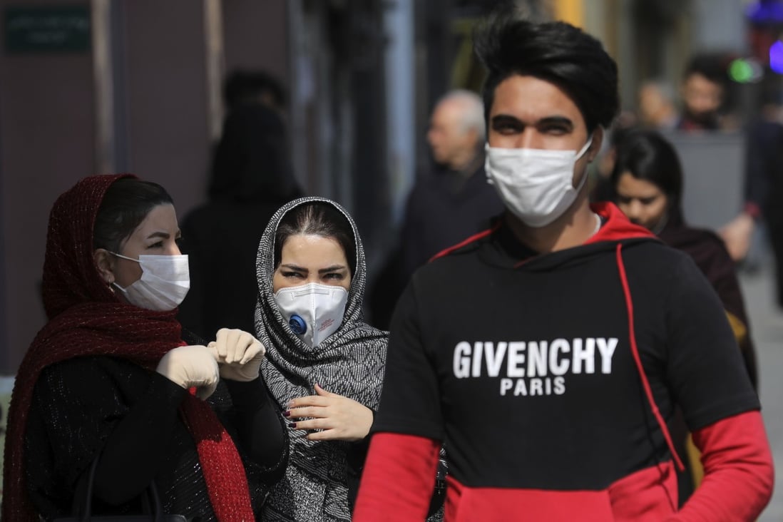 Pedestrians in Tehran wear masks amid an outbreak of coronavirus in Iran. Photo: AP