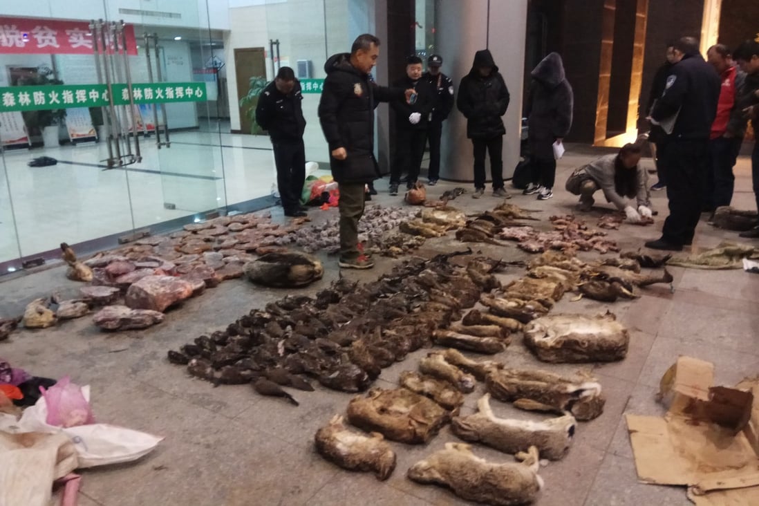 Police in Guangde, Anhui province, look at items seized from a store suspected of selling wildlife. Photo: Anti-Poaching Special Squad via AP
