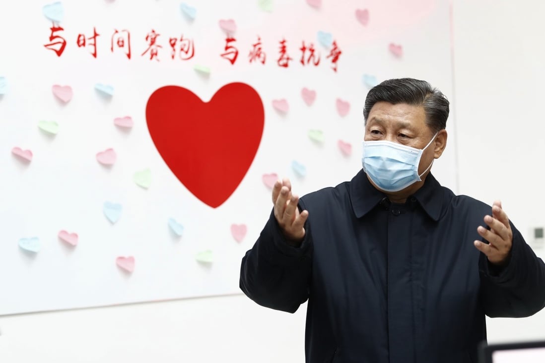 Chinese President Xi Jinping gestures near a heart-shaped sign and the slogan “Race against time, fight the virus” during an inspection of Chaoyang District’s centre for disease control and prevention in Beijing on February 10. Photo: Xinhua