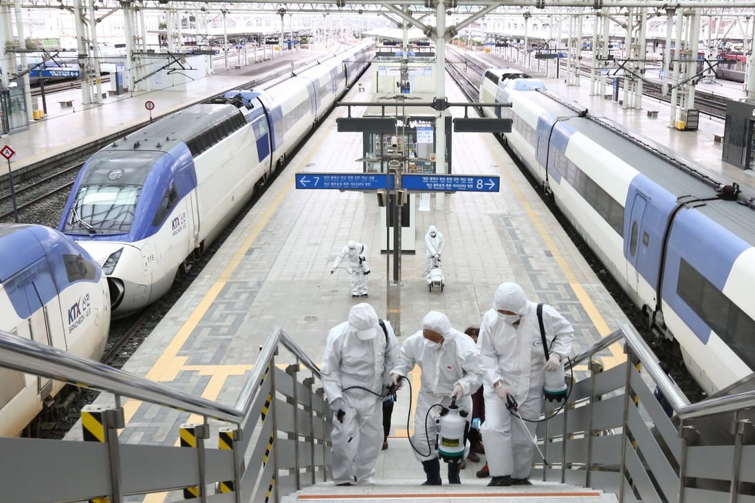 Workers spray disinfectant at Seoul station. Photo: EPA-EFE