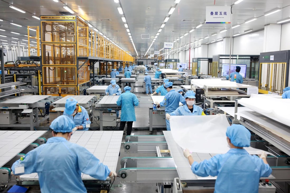 Employees on a photovoltaic solar panel assembly line at Risen Energy in Ningbo in Zhejiang province on February 21, 2019. Zhejiang Daily via Reuters