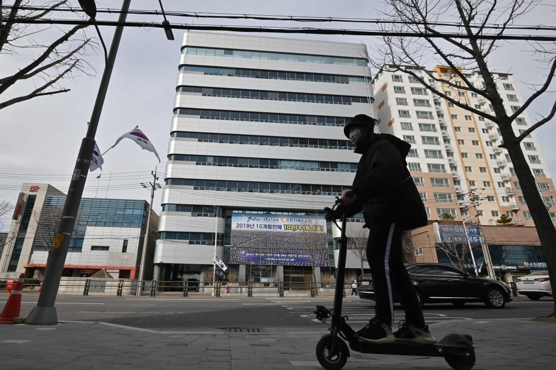 A man wearing a face mask rides an electric scooter in front of the Daegu branch of the Shincheonji Church of Jesus. Anger and frustration at the controversial church has grown, after a cluster of infections were linked to it. Photo: AFP