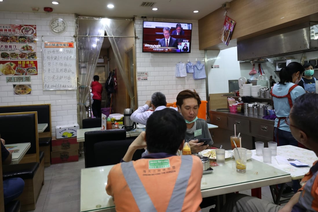 A television plays Financial Secretary Paul Chan delivering the 2020/21 budget at a restaurant in Sham Shui Po. Photo: Xiaomei Chen
