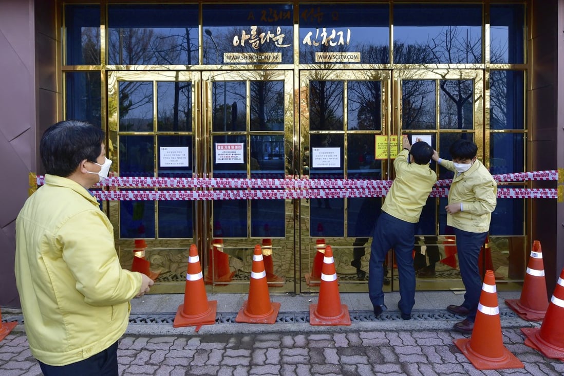 Government officials close down a branch of the Shincheonji Church of Jesus in Gwangju, South Korea. Photo: Newsis via AP