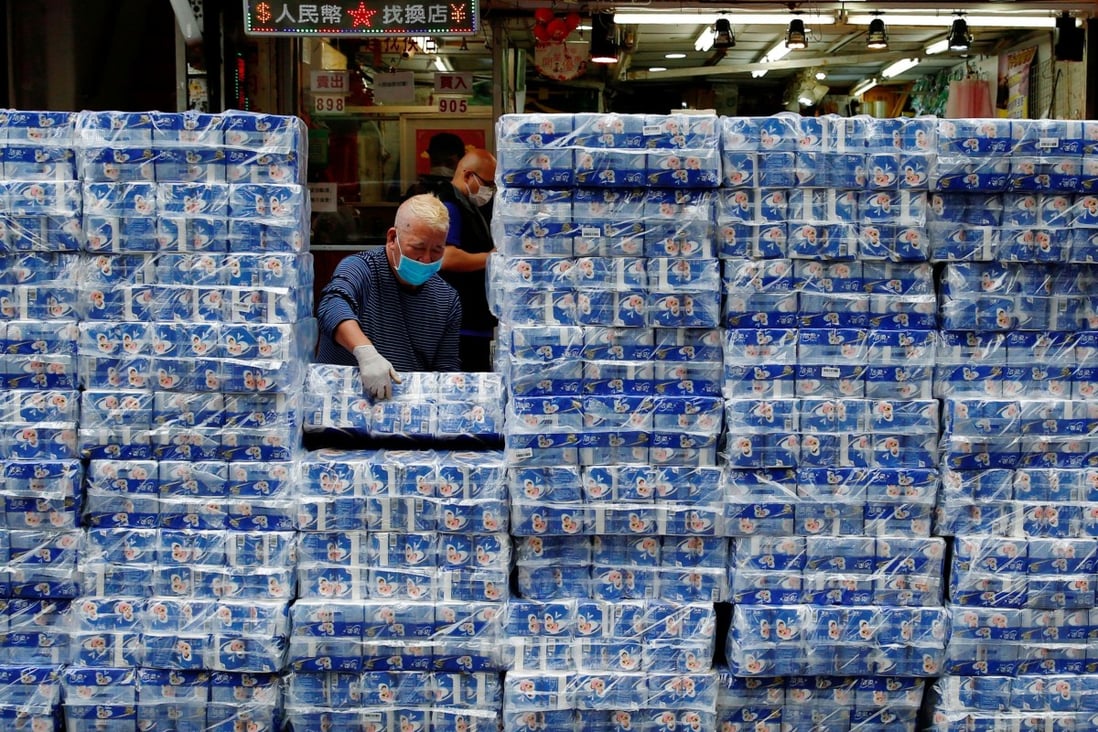 An employee restocks rolls of toilet paper at a market in Hong Kong, where fears over the supply chain from China has sparked panic buying. Photo: Reuters