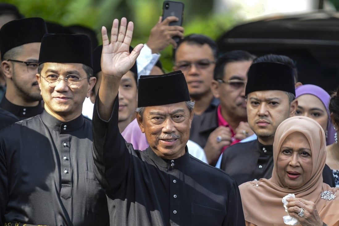 Malaysia's new Prime Minister Muhyiddin Yassin waving outside his residence before his inauguration on Sunday. Photo: Handout