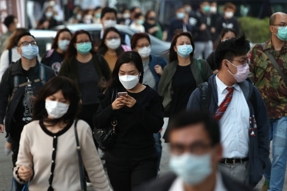 Pedestrians on the streets of Kowloon Bay wear masks amid the coronavirus outbreak in Hong Kong on February 27. Photo: Xiaomei Chen