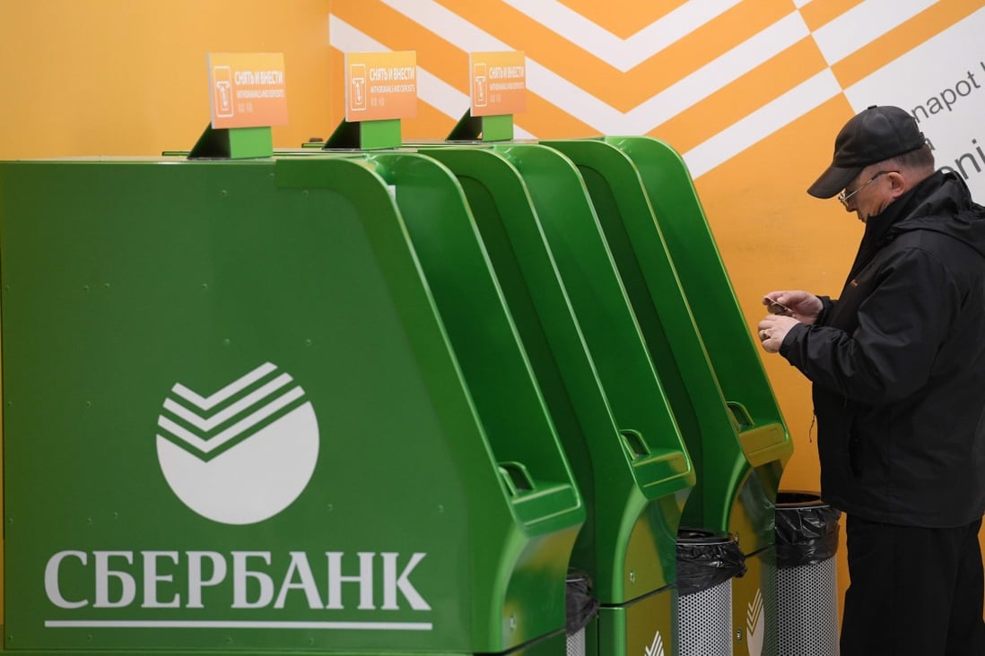 A man stands by Sberbank cash machines at Moscow's Sheremetyevo airport terminal B. Photo: AFP
