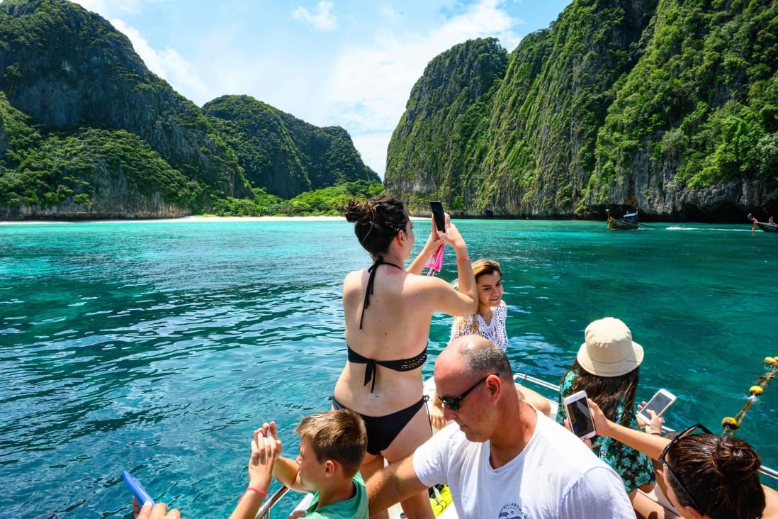 Tourists take pictures of Koh Phi Phi Leh, in Thailand. Photo: AFP