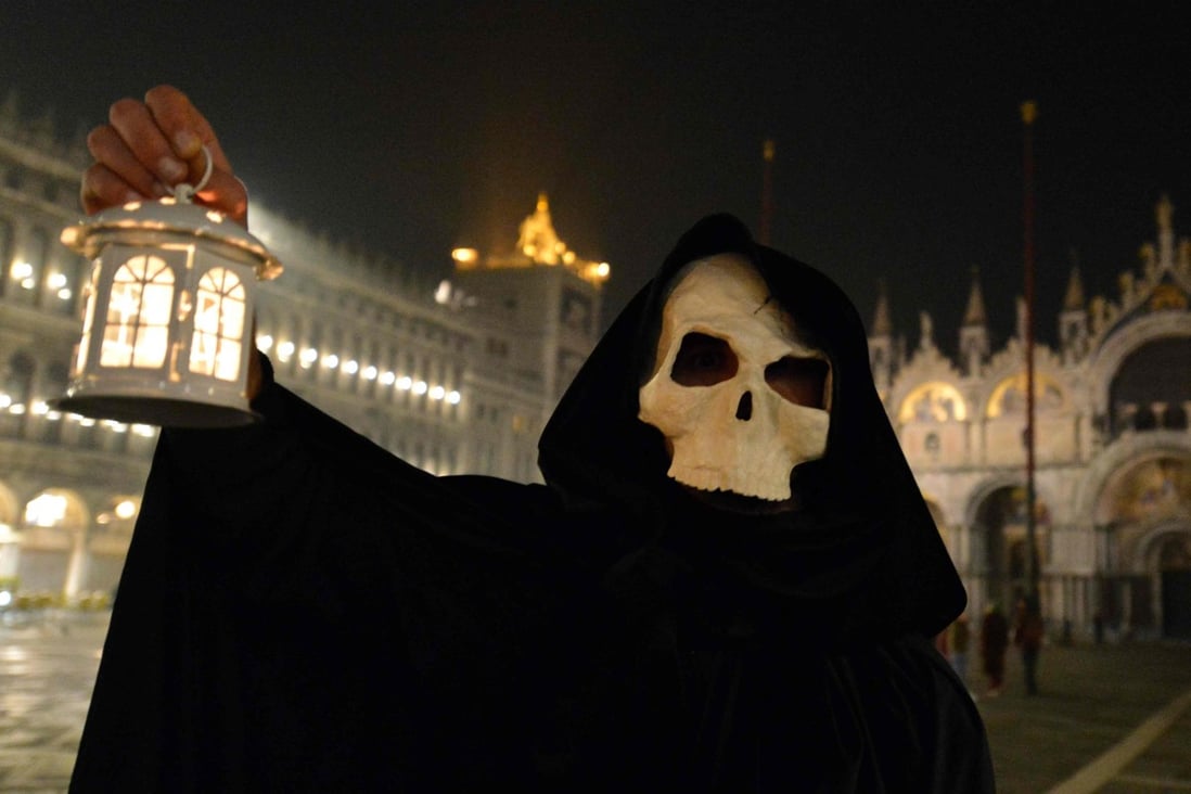 A masked reveller takes part in the ‘Plague Procession’ on Saint Mark Square in Venice, during the usual period of the Carnival festivities which have been cancelled following an outbreak of the Covid-19 novel coronavirus in northern Italy. Photo: AFP