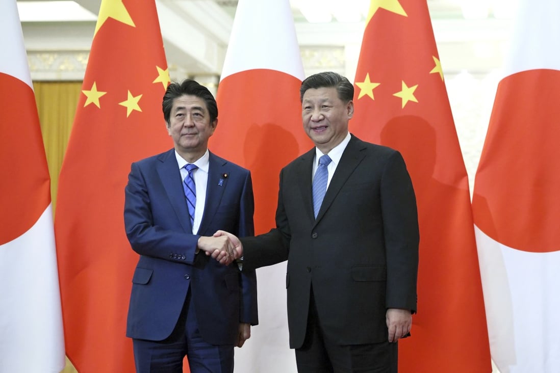 Japanese Prime Minister Shinzo Abe (left) meets Chinese President Xi Jinping in Beijing in December. Xi’s state visit to Japan has been postponed. Photo: AP