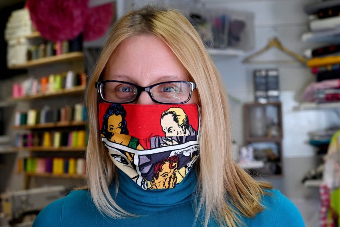 A woman wears a colourful face mask created by Croatian fashion designer Zoran Aragovic. His cotton masks in distinctive pop-art style are designed to counter fears of coronavirus, not the virus itself, he says. Photo: AFP