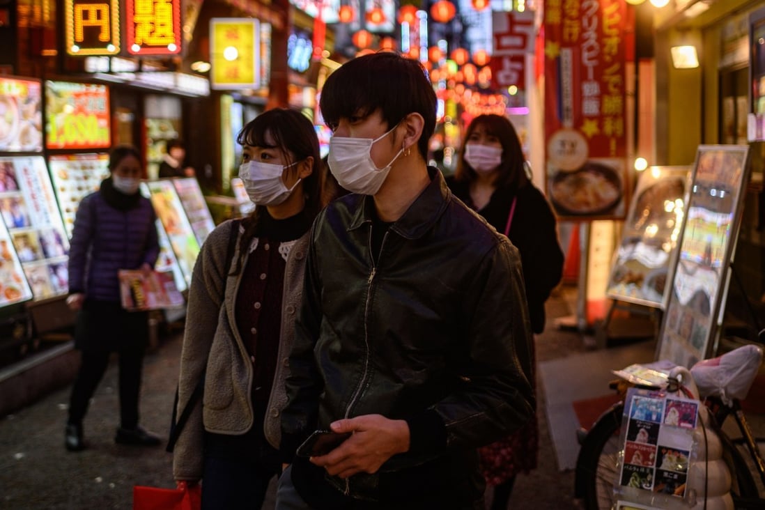 Pedestrians seen in protective face masks in Yokohama on February 23, 2020. Photo: AFP