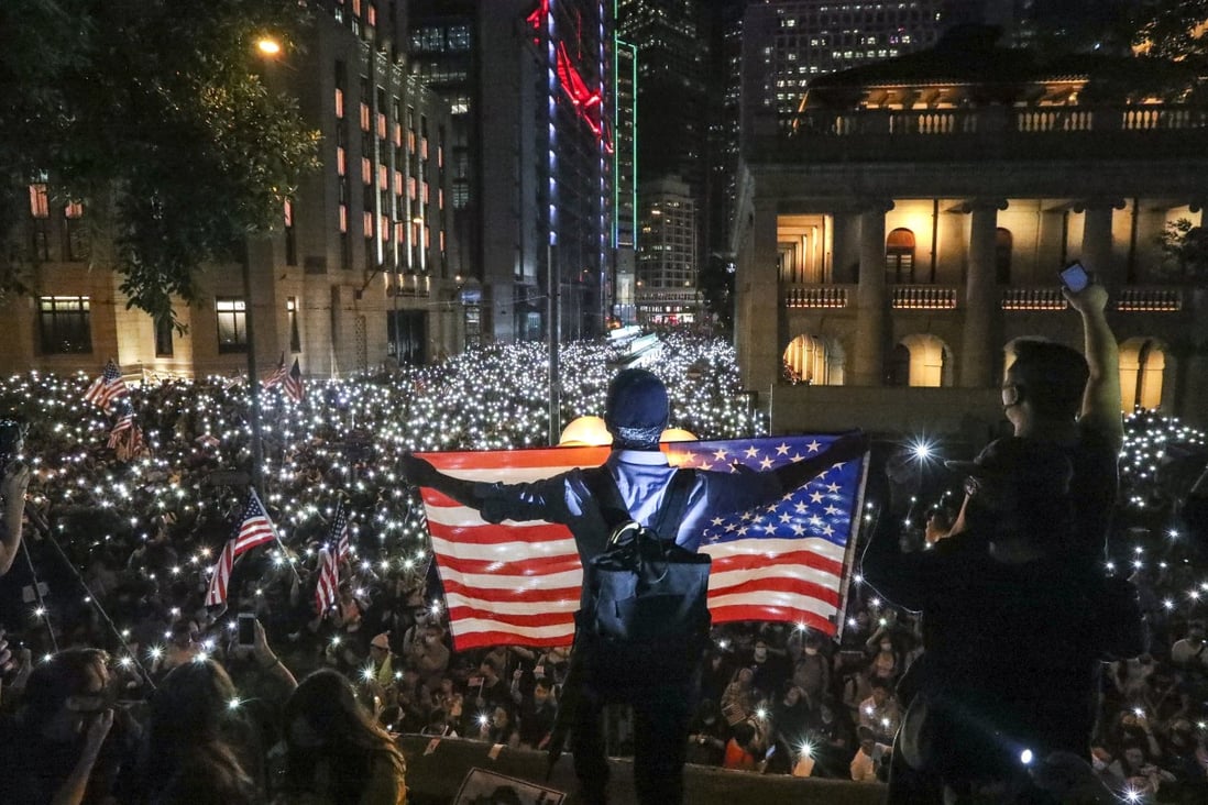 Anti-government protesters wave the US flag during a rally to urge US lawmakers to pass the Hong Kong Human Rights and Democracy Act last year. Photo: Felix Wong
