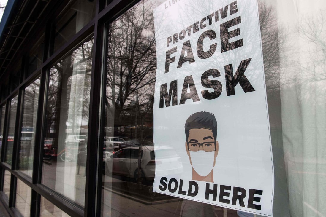 A sign for face masks is seen in the window of a coronavirus pop-up store in Washington on Friday. Photo: AFP