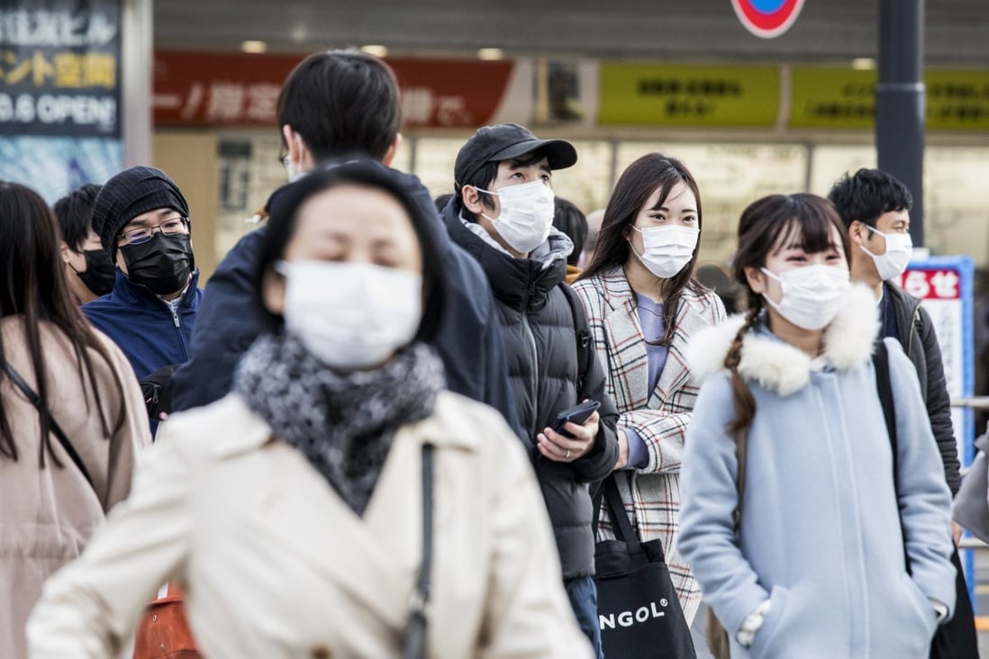 Commuters seen in protective masks in Tokyo on February 25, 2020. Photo: Bloomberg
