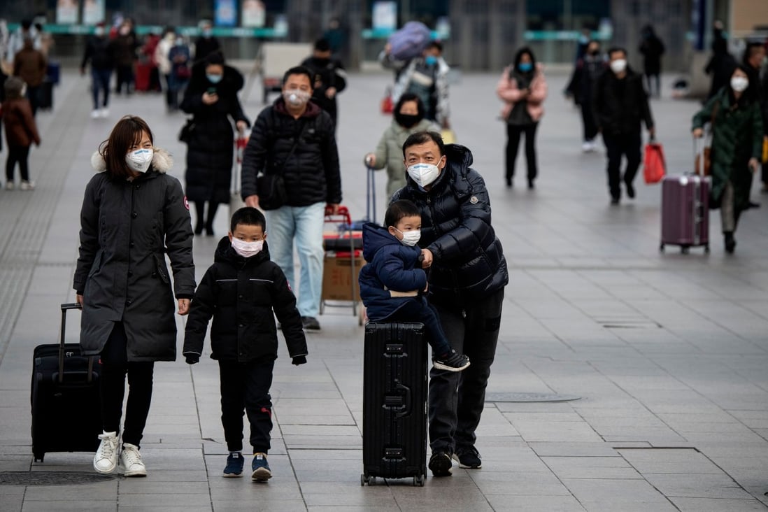 Passengers wearing facemasks arrive from different provinces at the Beijing Railway Station on February 1, 2020. Photo: AFP