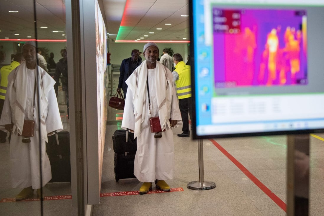 Moroccan health workers scan passengers arriving from Italy at Casablanca Mohammed V International Airport. Photo: AFP