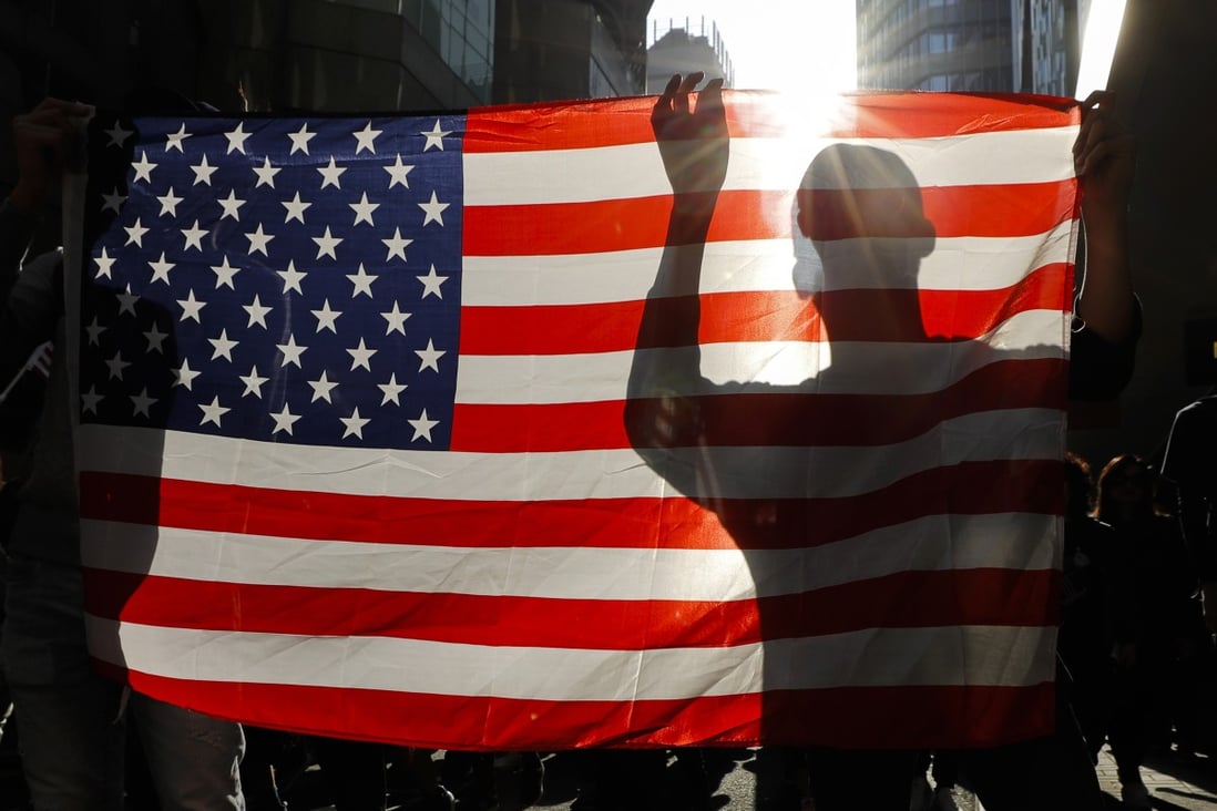 Protesters hold up a US flag at an anti-government rally in Hong Kong on December 1 last year. Photo: AP
