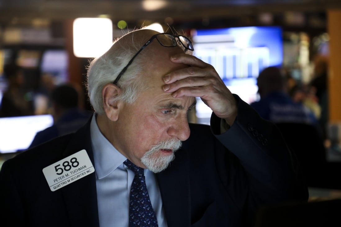 A trader reacts at the New York Stock Exchange on March 9. The Dow Jones Industrial Average, the S&P 500 and the Nasdaq Composite Index all notched up their worst daily declines in years over concerns of a possible oil price war and economic slowdown resulting from the coronavirus. Photo: Xinhua