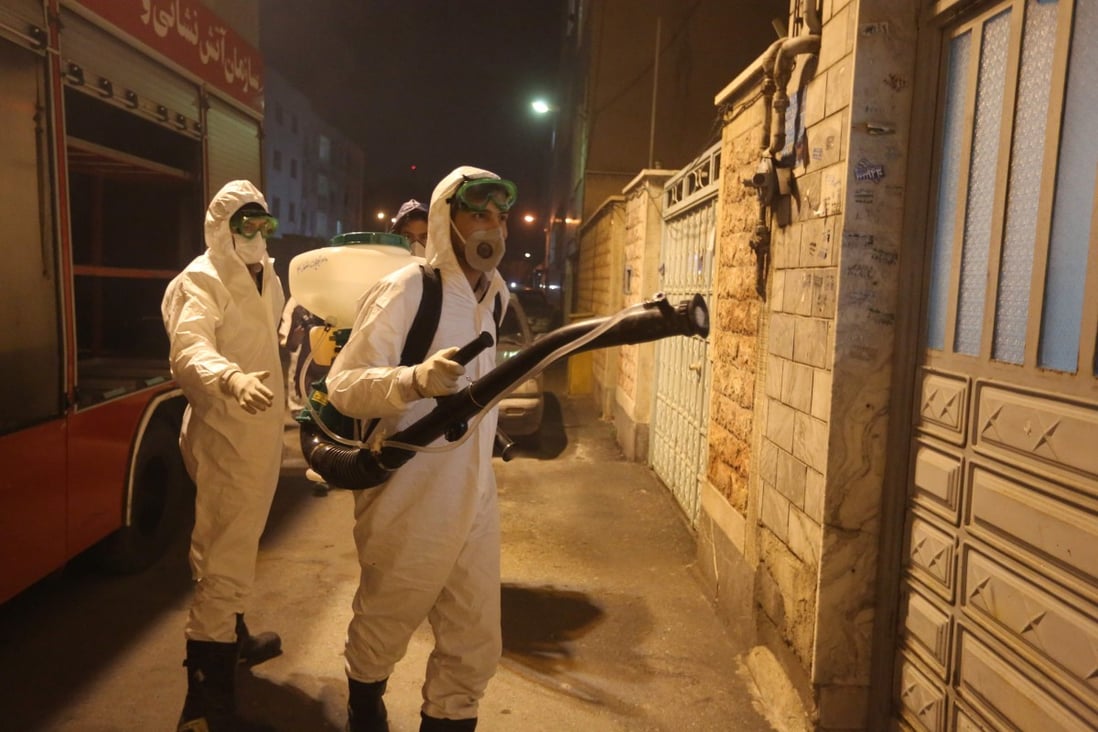 Iranian firefighters disinfect streets and alleys in Tehran on Wednesday to halt the spread of the coronavirus. Photo: AFP