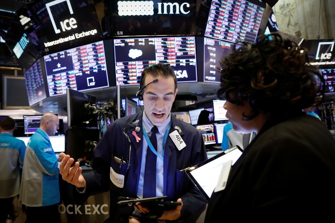 Traders work on the floor of the New York Stock Exchange near the close of trading in New York on Thursday. Photo: Reuters