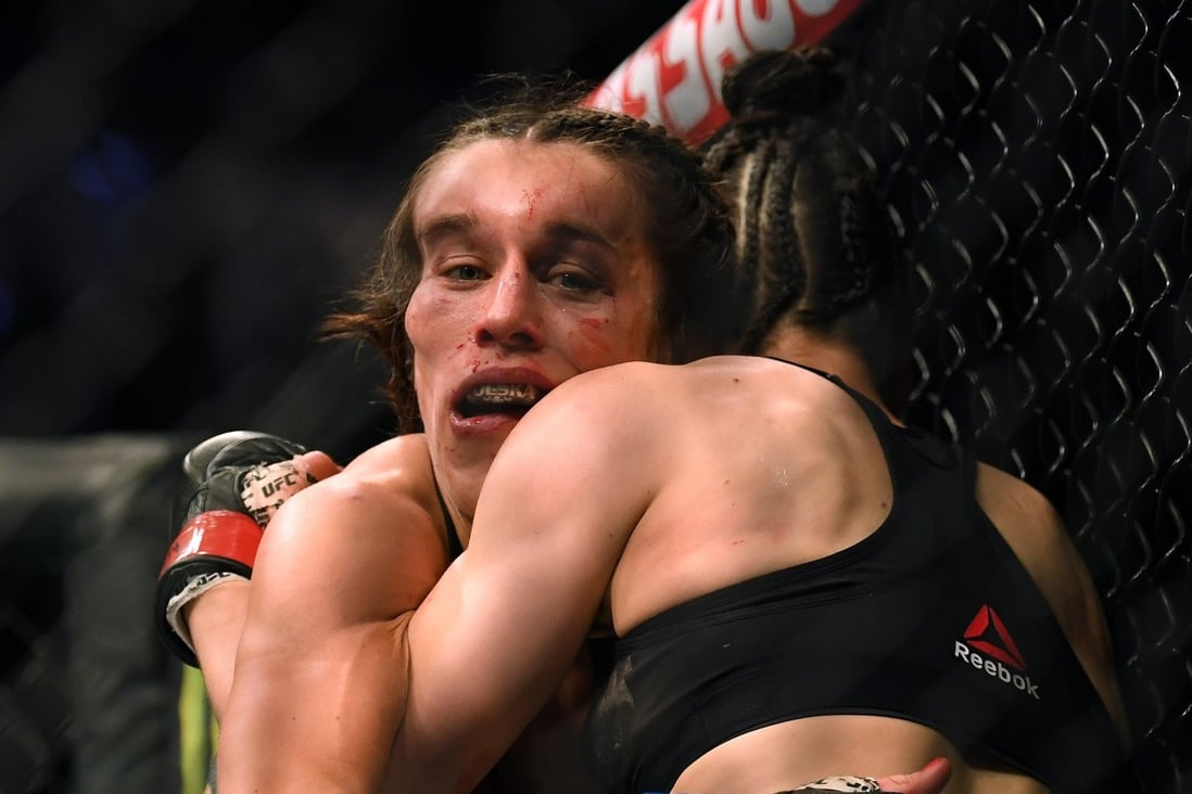 Joanna Jedrzejczyk hangs on to Zhang Weili in a split decision loss during their strawweight title bout at UFC 248. Photo: AFP