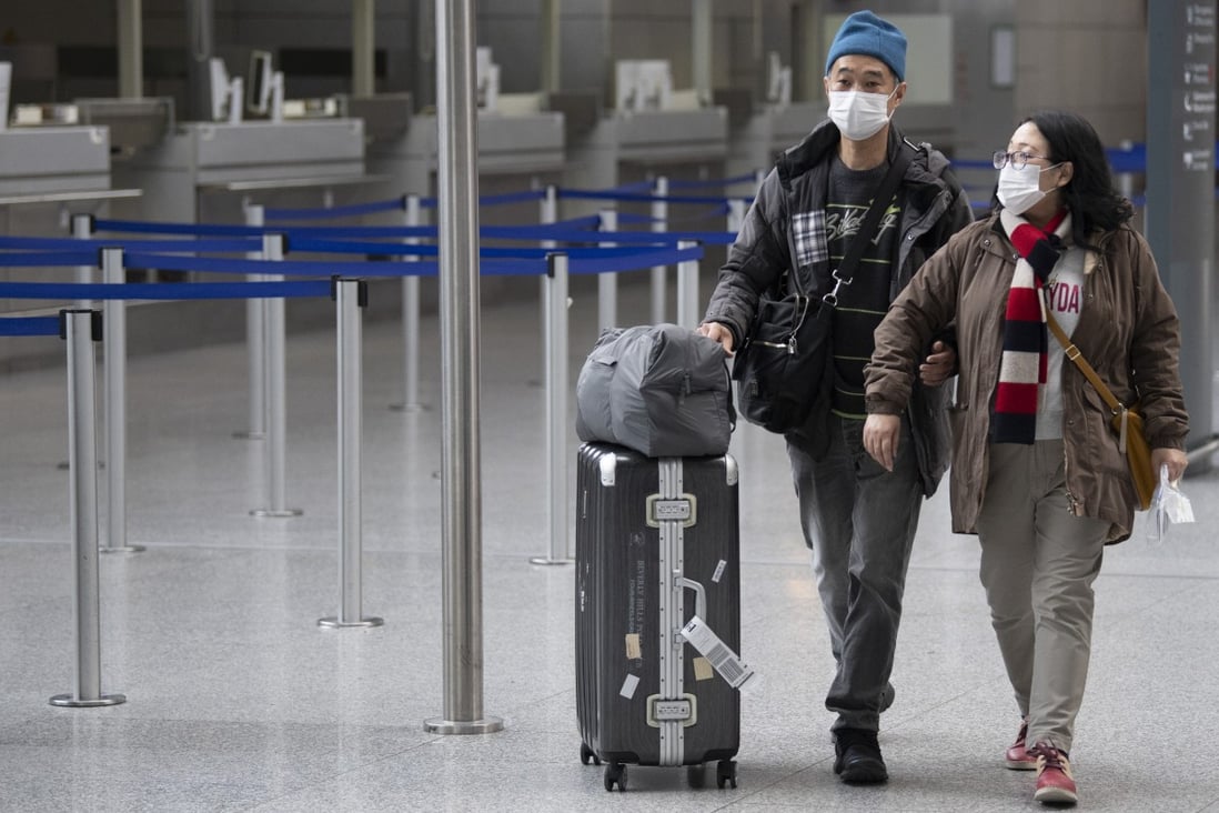 Passengers wearing masks make their way through the terminal at Frankfurt airport in Germany. Photo: AP