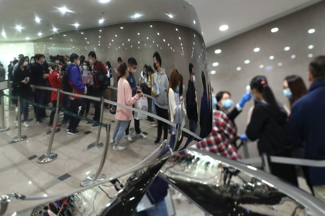 Buyers queuing for Wheelock’s Ocean Marini flats at its sales office in Tsim Sha Tsui. The 90 per cent take-up rate offers a glimmer of hope for property agents even as the overall market limps. Photo: Edmond So