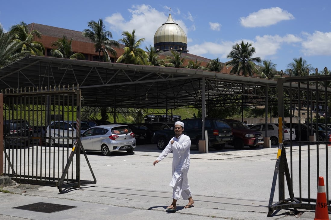A man walks out from the Sri Petaling mosque in Kuala Lumpur, Malaysia, on Monday. Photo: AP