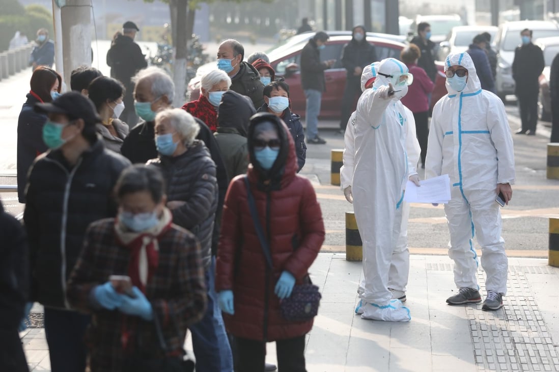 Recovered patients line up to be tested again at a hospital in Wuhan on Saturday. Researchers found unrecognised cases “can expose a far greater portion of the population to the virus than would otherwise occur”. Photo: AFP