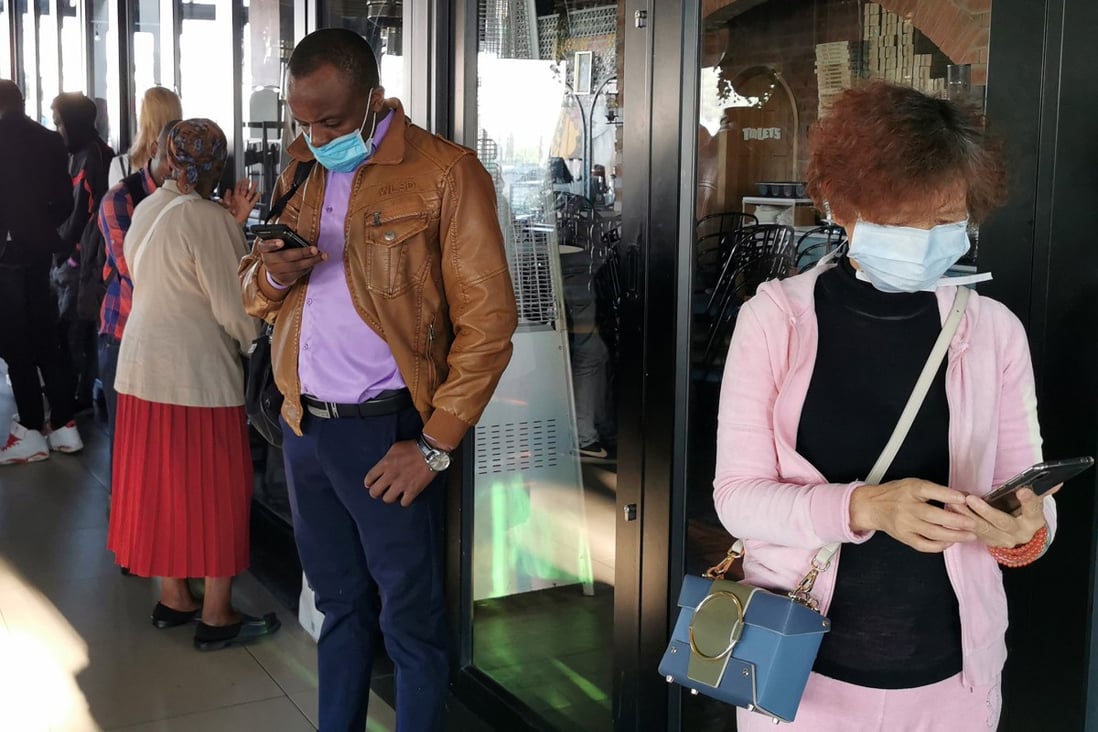 People in face masks outside a visa centre in Johannesburg, South Africa. Photo: Xinhua