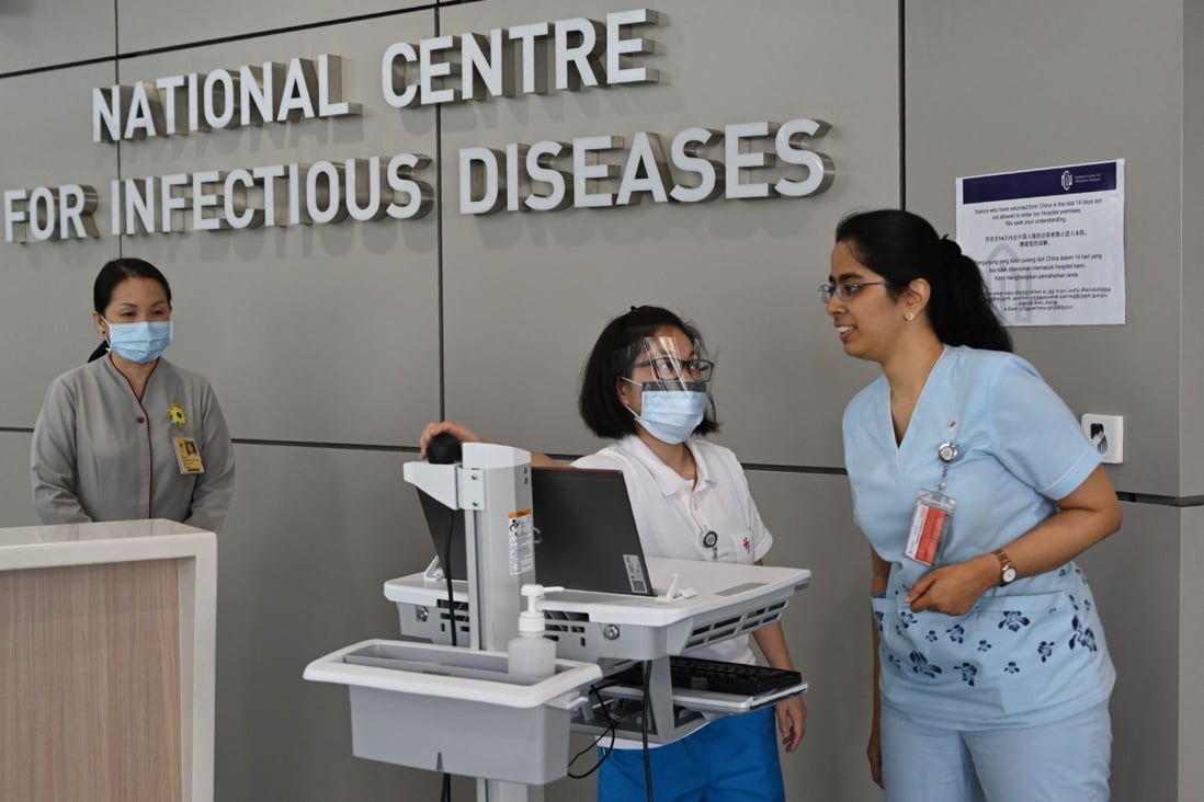 Medical staff undergo a pre-screening procedure at the National Centre for Infectious Diseases building at Tan Tock Seng Hospital in Singapore. The city state’s first two deaths were recorded at the centre on Saturday. Photo: AFP