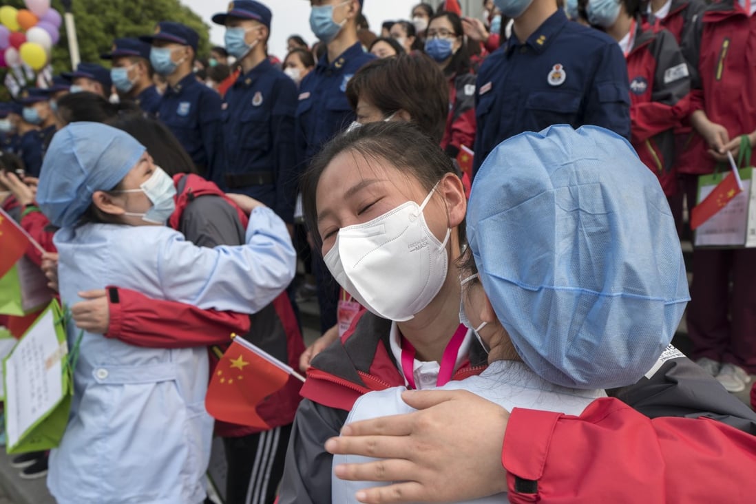 Medical workers from Tianjin say goodbye to colleagues they have been helping in Wuhan, which has reported no new cases for three days. Photo: Xinhua