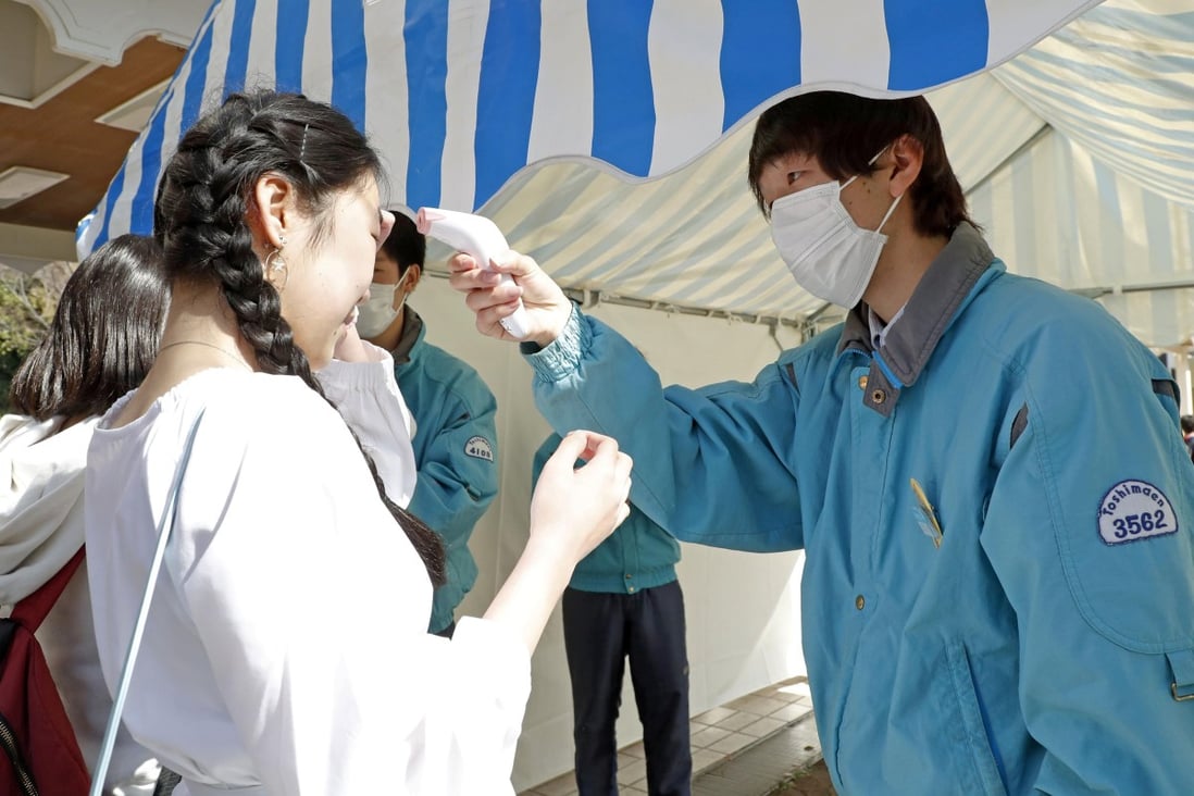 A visitor receives a temperature check as she enters the Toshimaen amusement park in Tokyo, which reopened after a three-week closure to prevent the spread of Covid-19, the disease caused by the coronavirus. Photo: Reuters