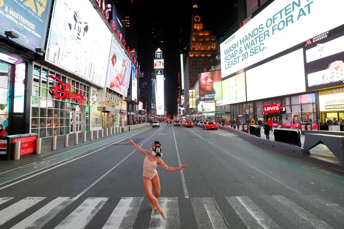 Ballet dancer Ashlee Montague wears a gas mask as she dances in Times Square, New York, on March 18. About two-thirds of coronavirus cases are occurring outside China now. Photo: Reuters