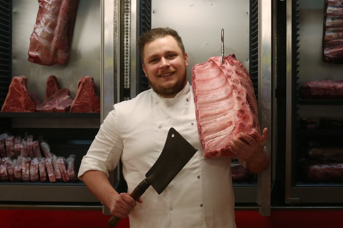 Chef Josh Stumbaugh holds bistecca steak at Associazione Chianti in Wan Chai, Hong Kong. The city is an ideal place to sample the full range of steak preparation and cooking styles because of the variety of its international restaurants. Photo: Jonathan Wong